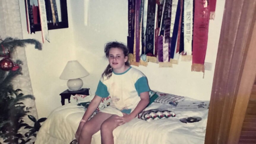 Rebel Wilson at home in Sydney as a child with her dog show ribbons displayed on the wall.