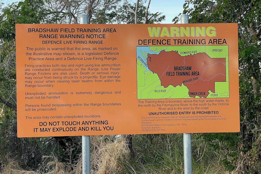 An orange warning sign tells of live firing on the bradshaw training area.