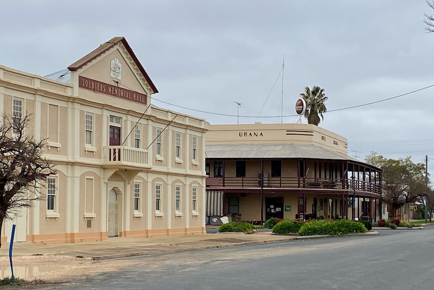 An empty street features a pub painted "urana" and a building labelled "soldiers memorial hall"