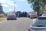 Police officers and police cars in a suburban street