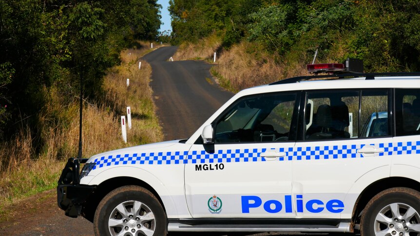 A NSW Police four-wheel drive parked across a country road.