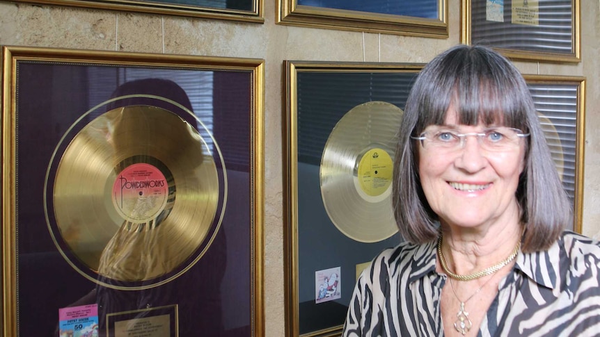 Patsy Biscoe standing in front of her gold records