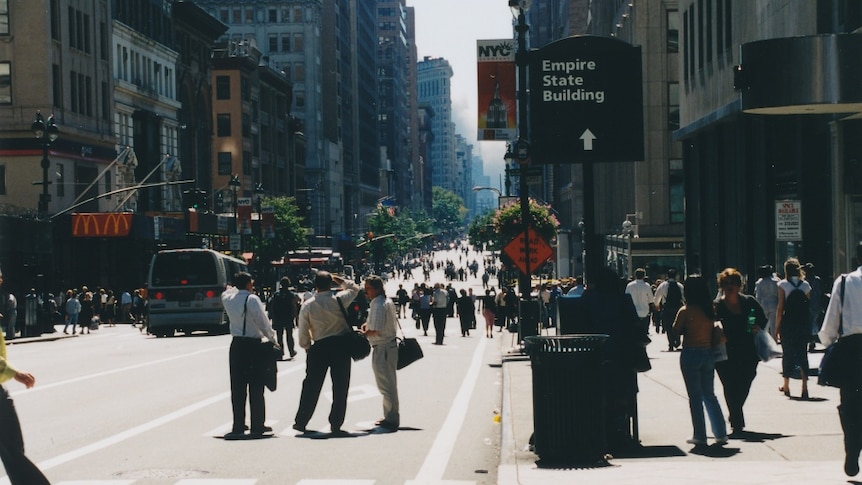 Pedestrians gather on 5th Avenue after the collapse of the World Trade Centre on September 11, 2001.