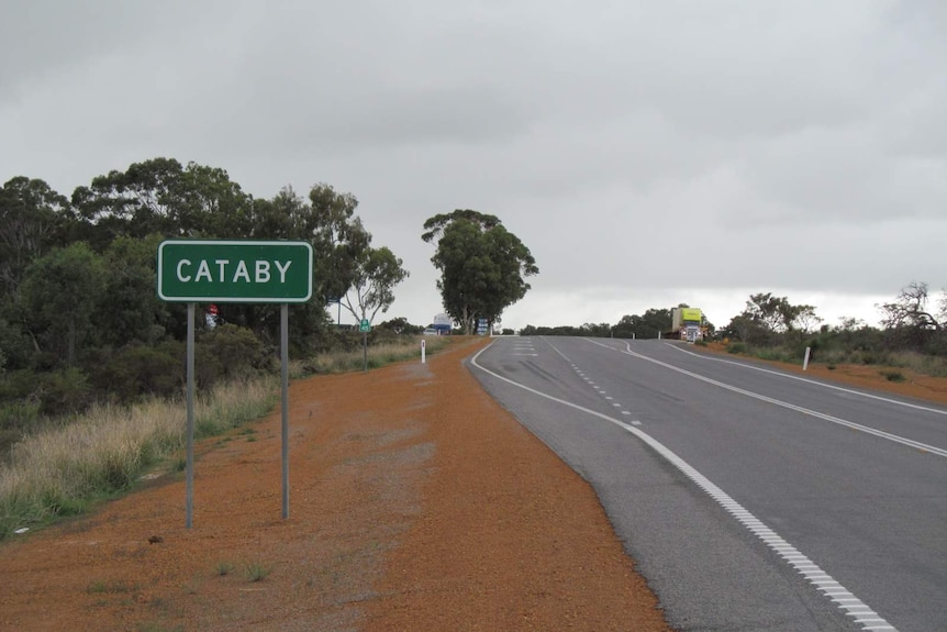 Road sign reading "Cataby" by the side of a bitumen road.