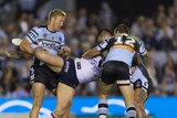 Boyd Cornder is held up by his leg by Matt Prior with his head held by Wade Graham