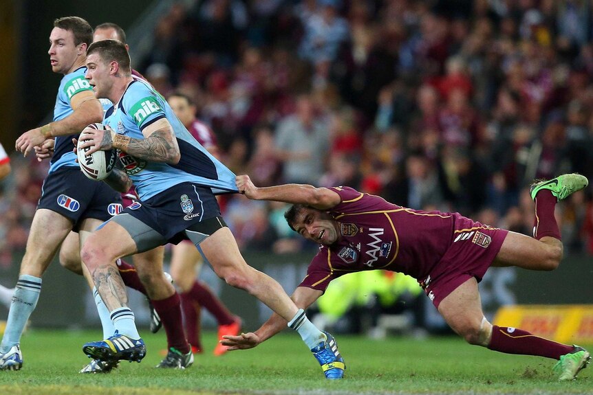 Josh Dugan is tackled by Cameron Smith.