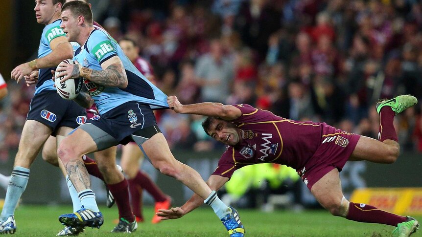 Josh Dugan is tackled by Cameron Smith.