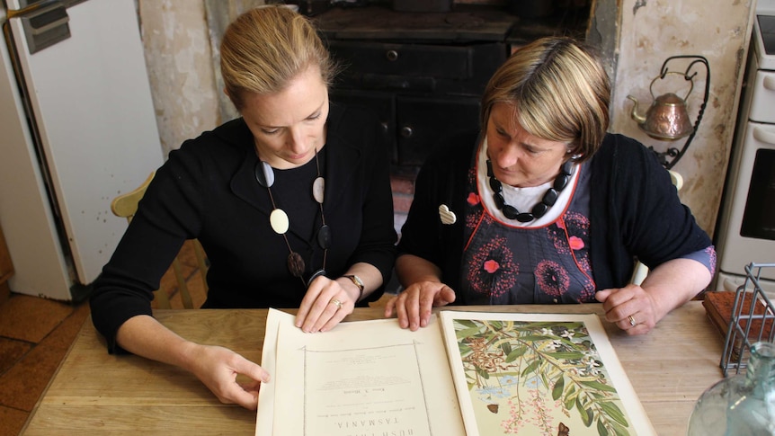 Geoffrey Stilwell's cousins, Georgie Stilwell (left) and Jo Thalmann (right), viewing book up for sale.