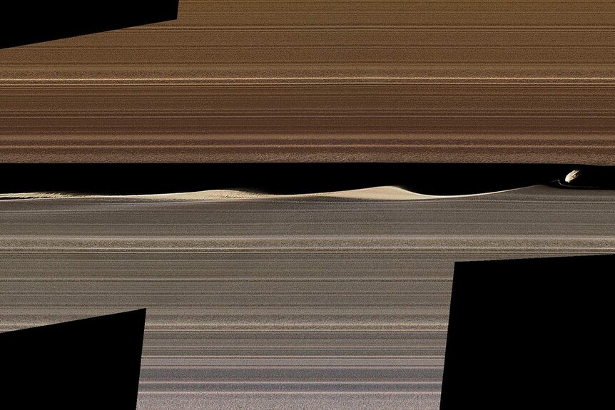 Saturn's moon Daphnis creating a gap in Saturn's A ring, with waves in its wake dissipating