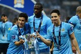 jesus Navas, Yaya Toure and Samir Nasri of Manchester City pose with the League Cup trophy.