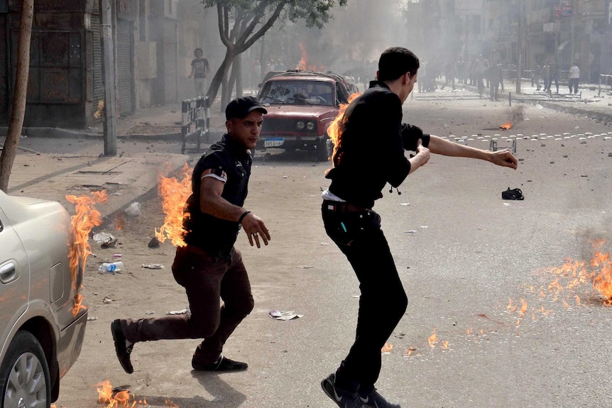 Coptic Christians put out burning clothes after attack.