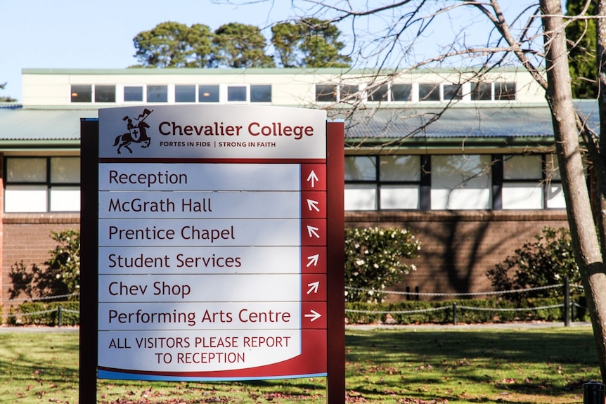 A board out the front of a school headed with "Chevalier College" and featuring a list of directions.