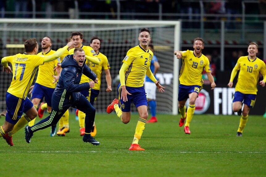 Sweden's players celebrate at the end of the World Cup qualifying play-off against Italy.