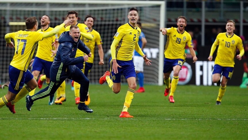 Sweden's players celebrate at the end of the World Cup qualifying play-off against Italy.