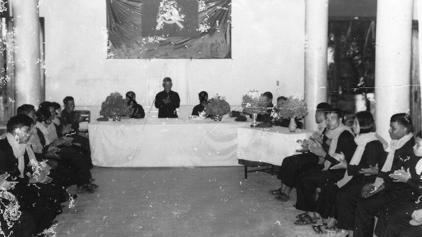 A black and white photo of a group wedding during the Khmer Rouge.
