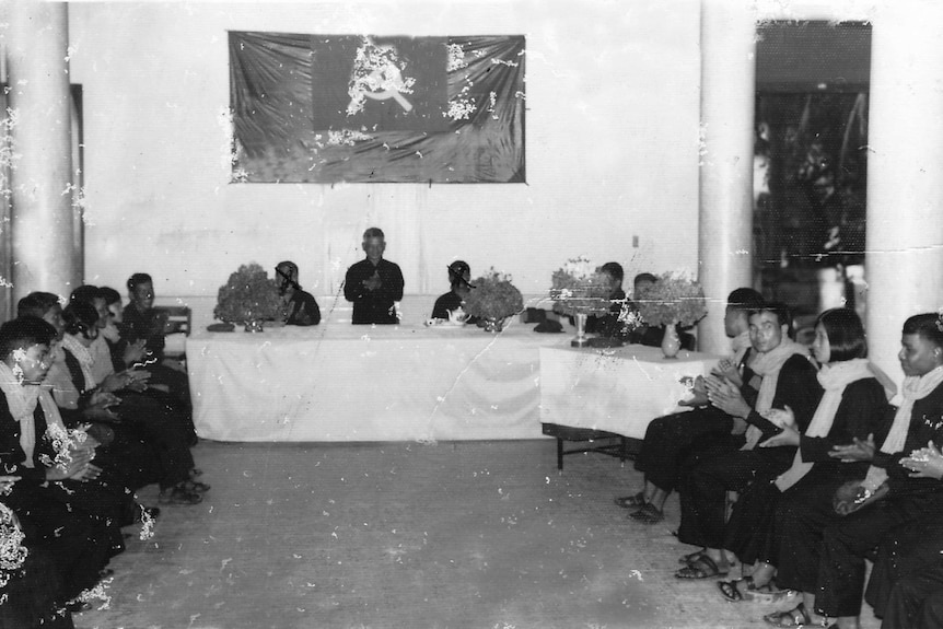 A black and white photo of a group wedding during the Khmer Rouge.