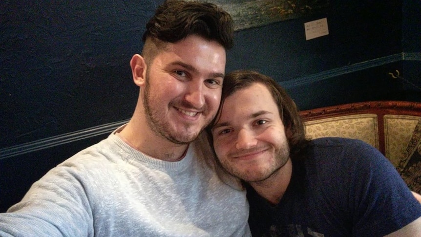 Mitch Broom puts his arm around partner Michael and takes a selfie