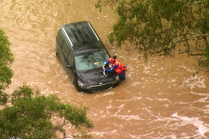 a car inundated in floodwaters