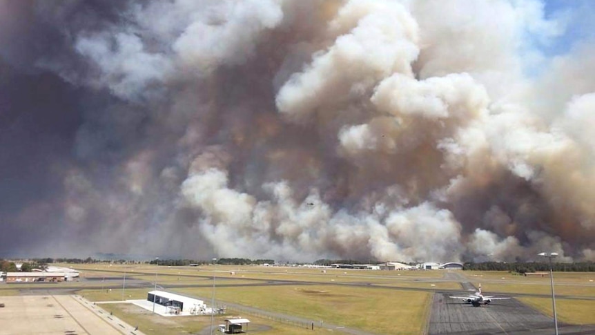 Smoke from a bushfire blows over Newcastle Airport.