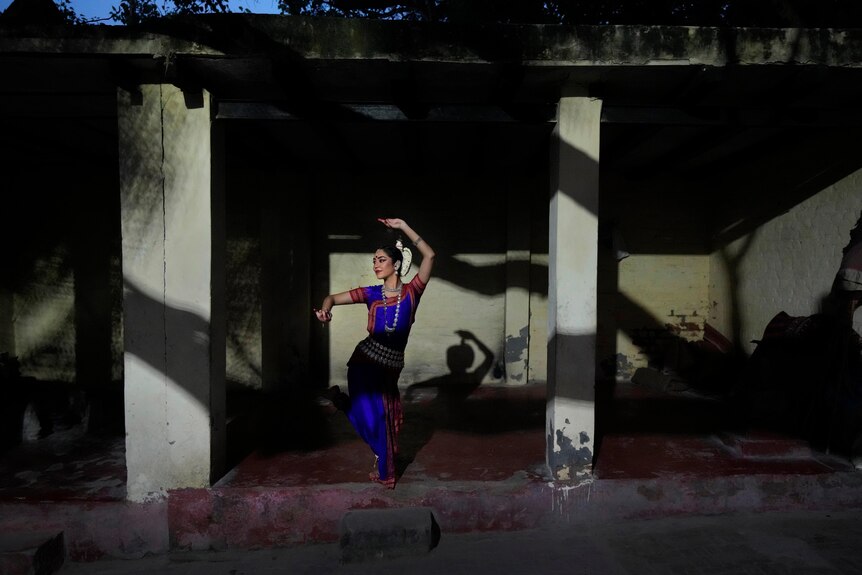 Woman dances in New Delhi, India.