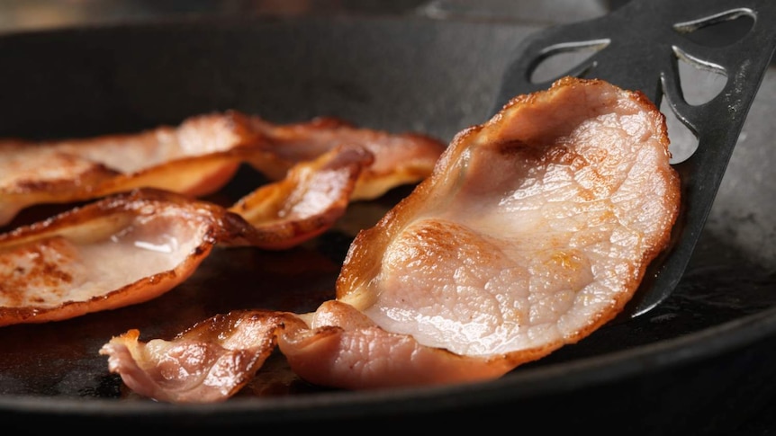 Bacon frying in a pan