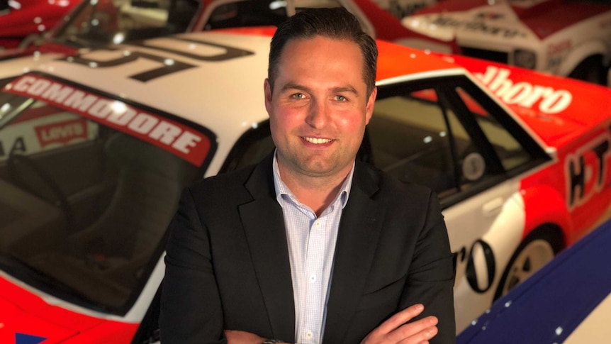 Lloyds Auctioneers and Valuers Chief Operations Officer, Lee Hames, standing in front of Peter Brock car collection