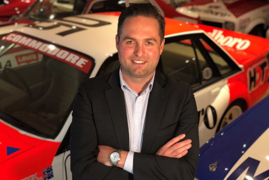 Lloyds Auctioneers and Valuers Chief Operations Officer, Lee Hames, standing in front of Peter Brock car collection