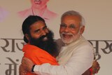 Billionaire godman Baba Ramdev hugs Indian PM Modi at a yoga festival in New Delhi in 2014.