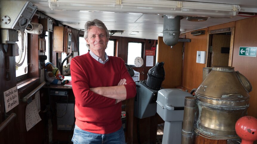 Steve Anthony poses for photo inside ship.