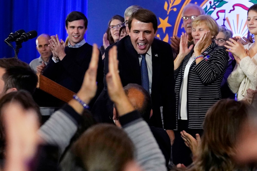 Charles Krupa is congratulated by supporters at an election night gathering.