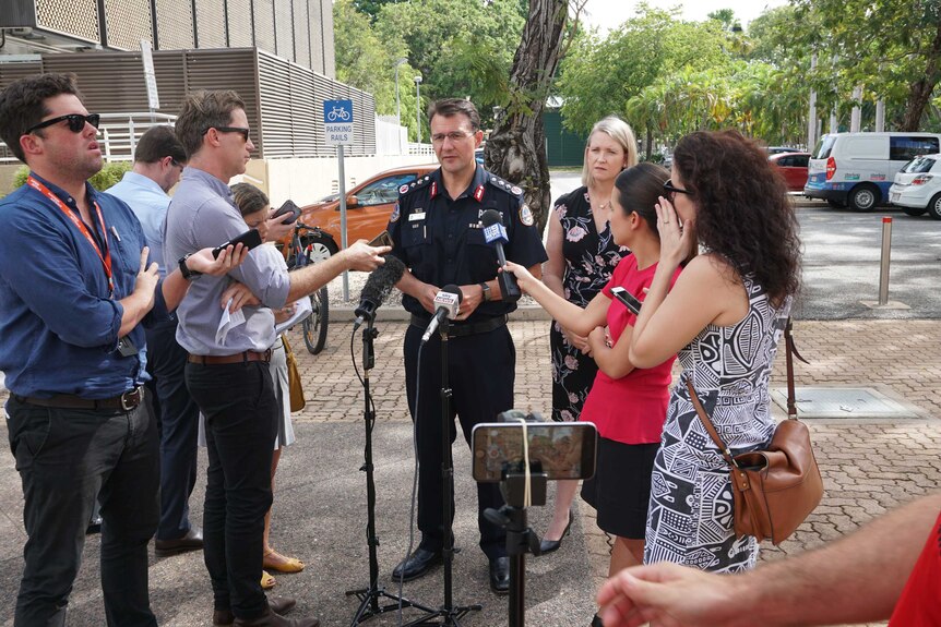 Journalists stand around Police Commissioner Reece Kershaw at a press conference
