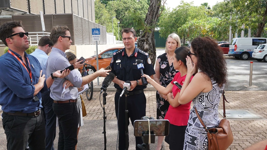 Journalists stand around Police Commissioner Reece Kershaw at a press conference