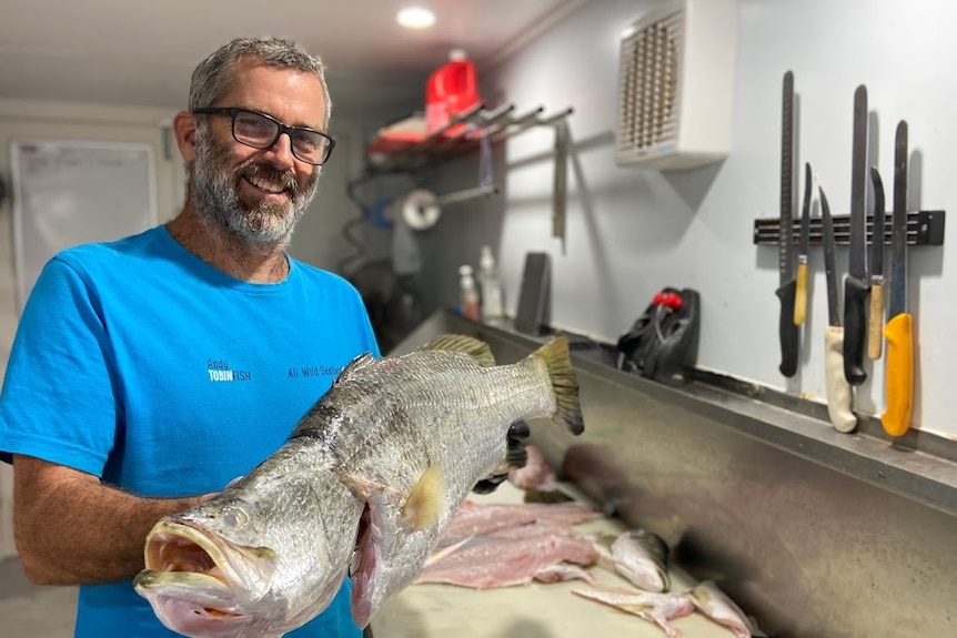 A man holds a fish