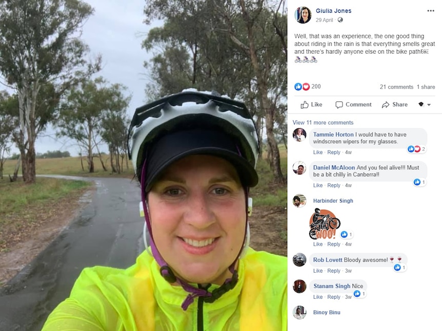 Giulia Jones in a fluro vest rides a bike in the rain.