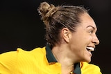 A Matildas player smiles as she celebrates scoring a goal against the USA.