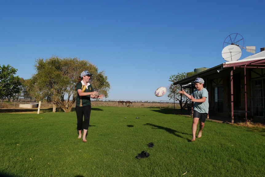 Lincon runs to the camera passing a football mid air to his sister