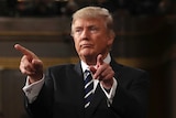 US President Donald Trump points with both hands.