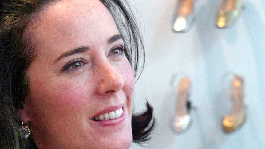 Close up of Kate Spade with her shoes in the background.