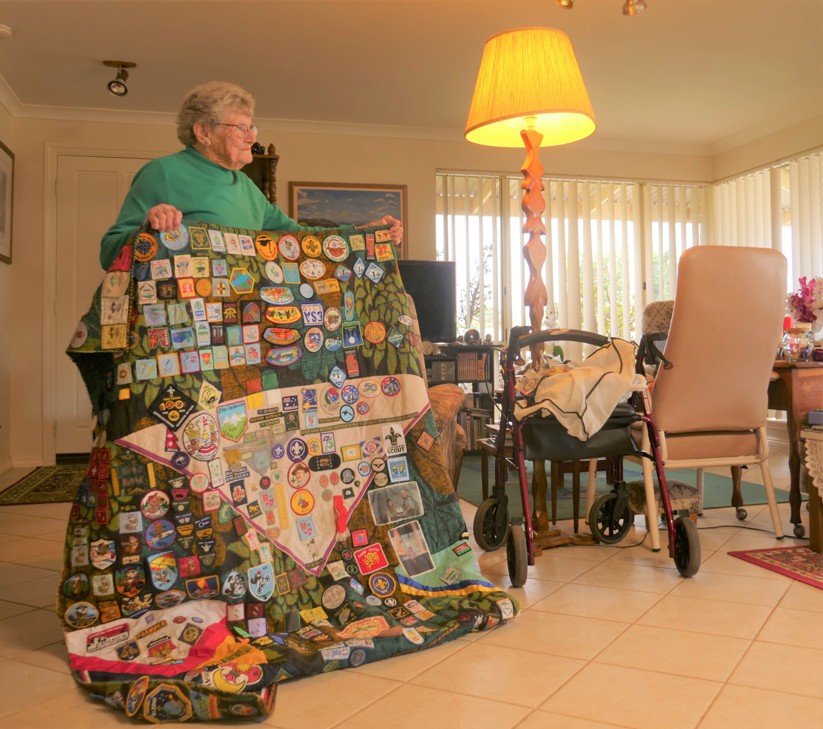 a woman holds a blanket up