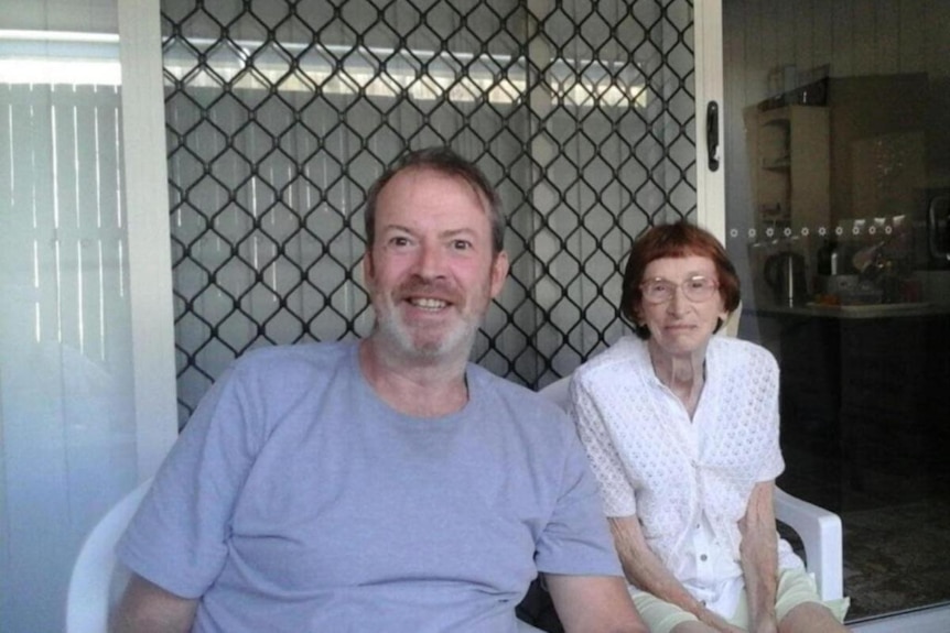 Adrian Meneveau and Felicity Loveday sit side-by-side, smiling at the camera.