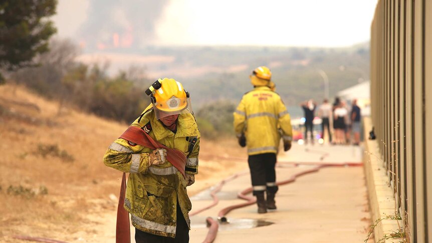 Some firefighters are stationed near Yanchep homes to protect them from the blaze burning in the area.