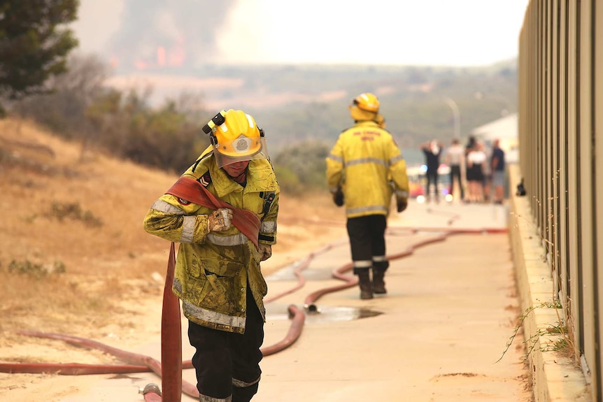 Some firefighters are stationed near Yanchep homes to protect them from the blaze burning in the area.