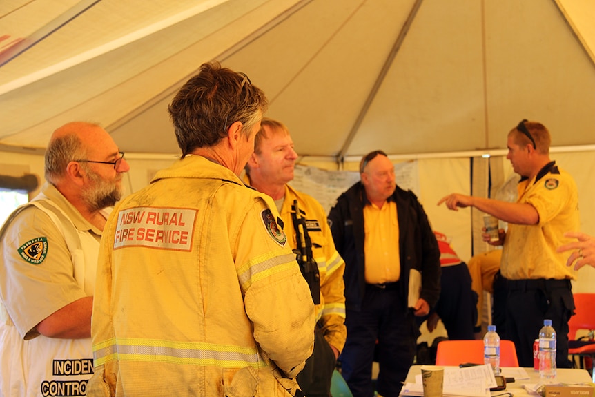 Firefighters inside a briefing tent