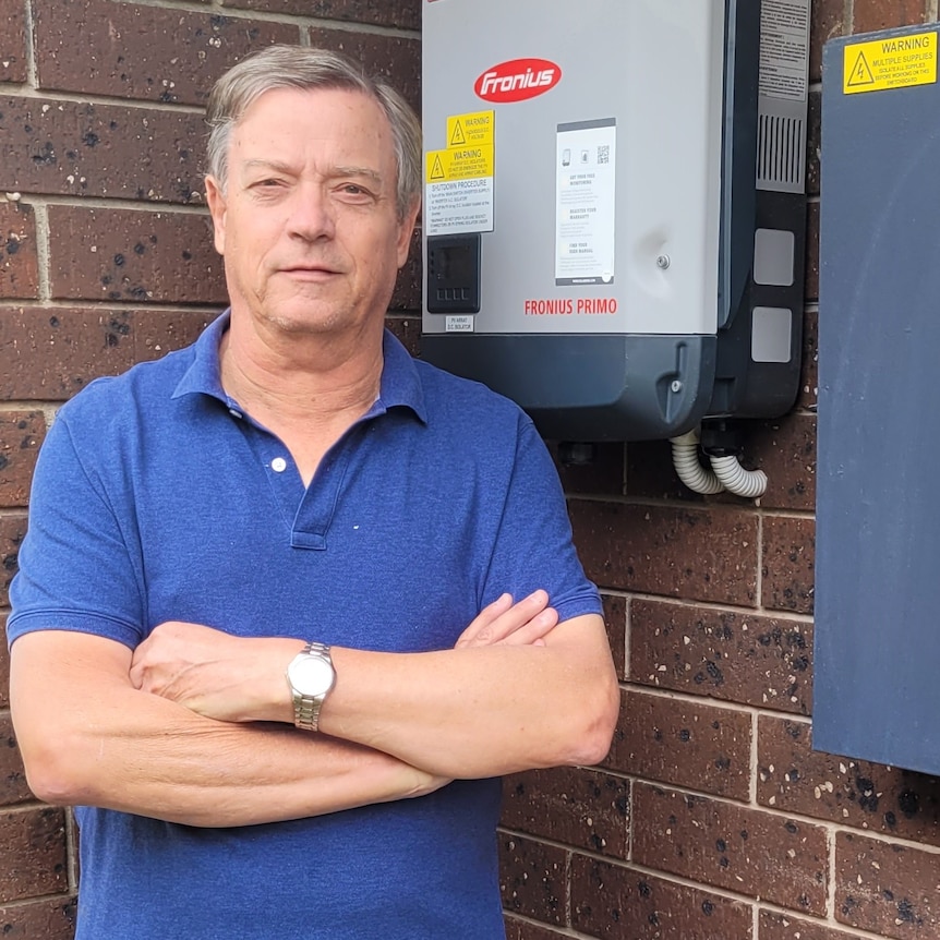 Keith Thomson standing beside his inverter