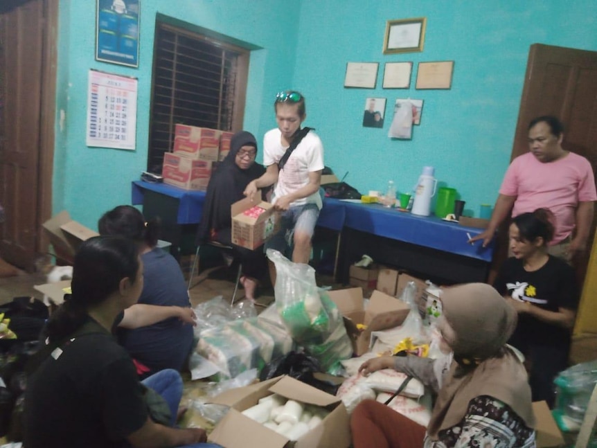 People sort out goods packed in boxes.