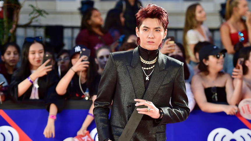 wu in a black suit and turtle neck on the red carpet