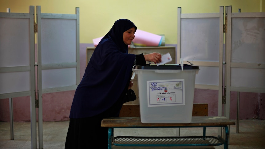 Second ballot ... A woman casts her vote at a polling station in Cairo.