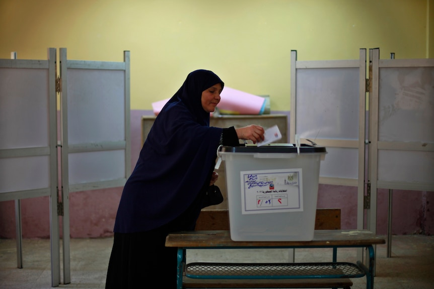 Second ballot ... A woman casts her vote at a polling station in Cairo.