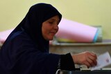 Second ballot ... A woman casts her vote at a polling station in Cairo.