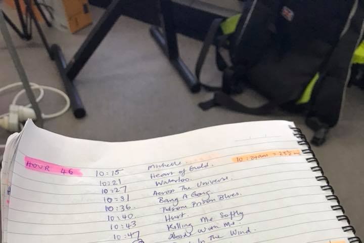 A notebook with a hand-written list of songs played by Scott Burford during his world record attempt.